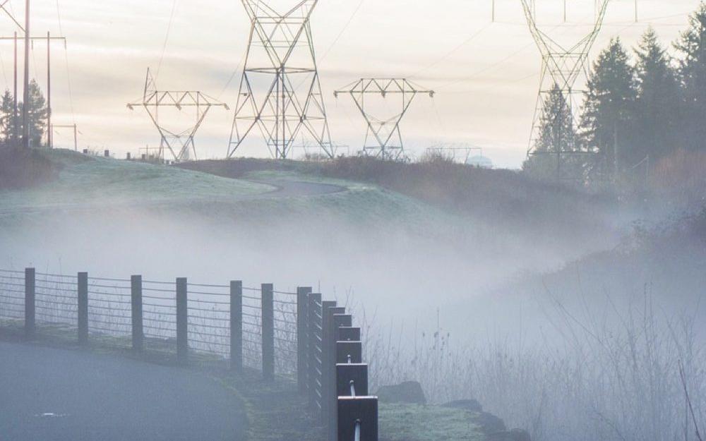 fogy fence in front of power lines