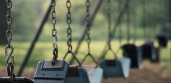 bunch of empty swings at a park