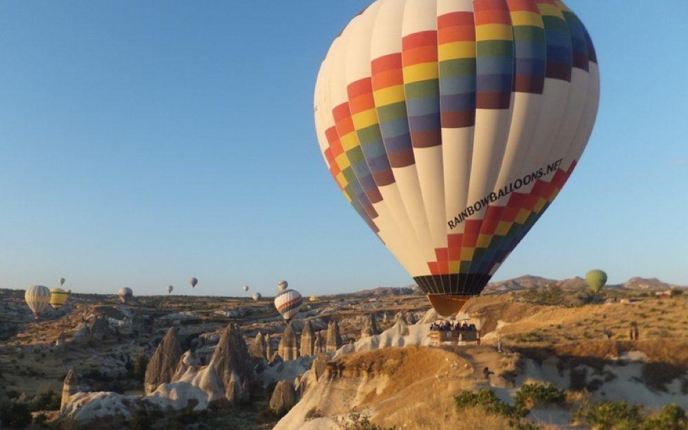 air balloons flying over a canyon  