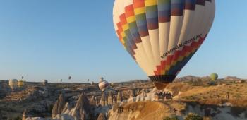 air balloons flying over a canyon
