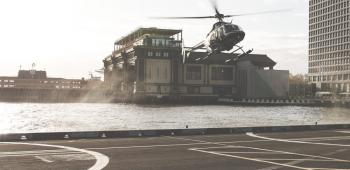 helicopter landing on a platform near water